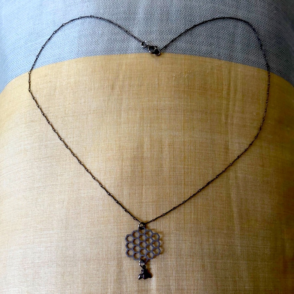 Delicate bee and honeycomb necklace.